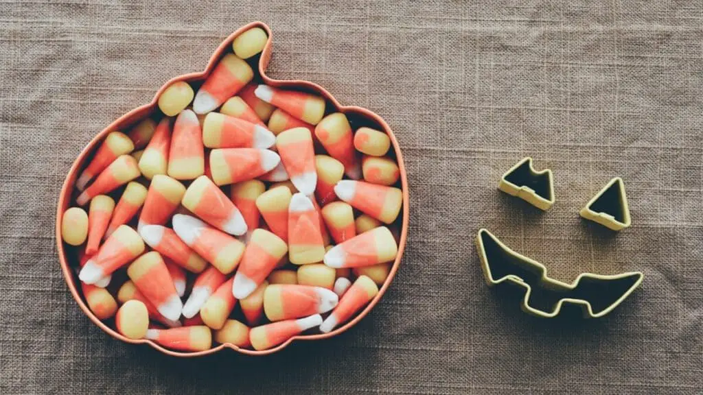 pumpkin cookie cutter with candy corn in it